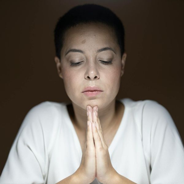 Woman with a calm and focused expression looking forward, symbolizing clarity and peace.